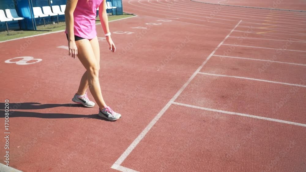 Fit girl in activewear standing at start line Fit girl in activewear standing at start line