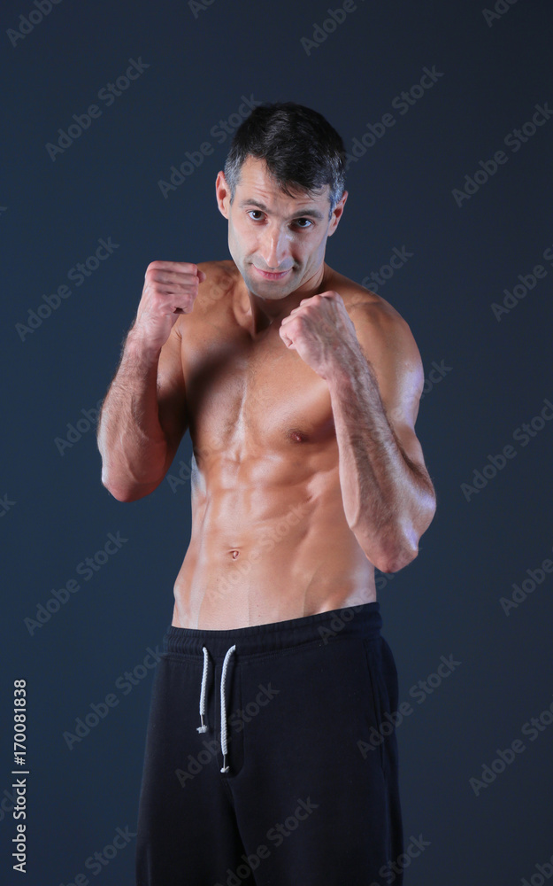 Profile view of young man practicing boxing .Personal instructor. Personal training.