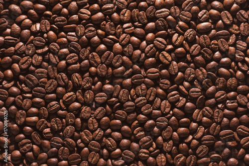 Roasted coffee beans on a flat background. © ktsdesign