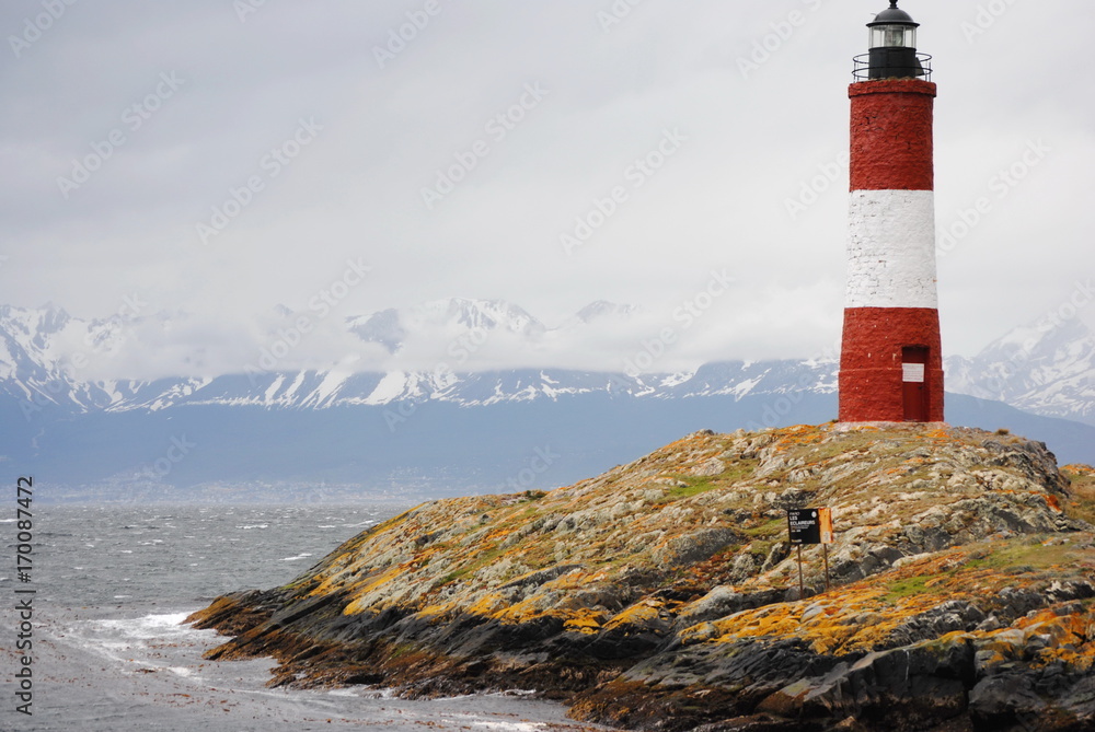 Red and white lighthouse in the Beagle Channel, Ushuaia, Tierra del Fuego, Argentina.  People call it End of the world's lighthouse.  It's name is Les Eclaireus.