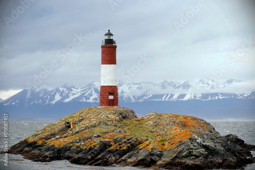 Red and white lighthouse in the Beagle Channel, Ushuaia, Tierra del Fuego, Argentina. People call it End of the world's lighthouse. It's name is Les Eclaireus.