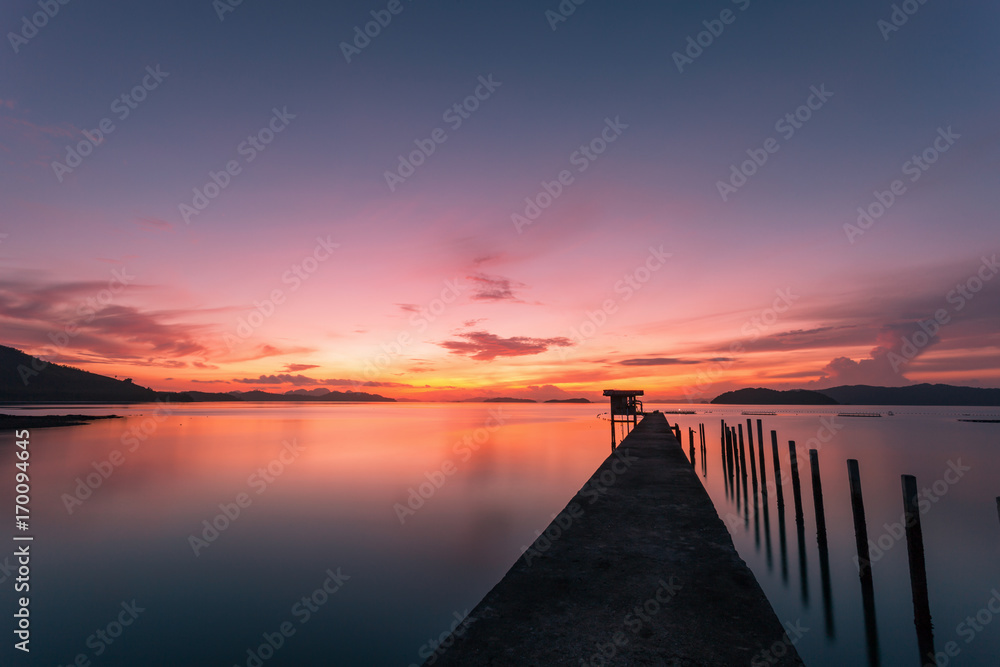 scenery view of old jetty to the sea beautiful sunrise or sunset in phuket thailand.