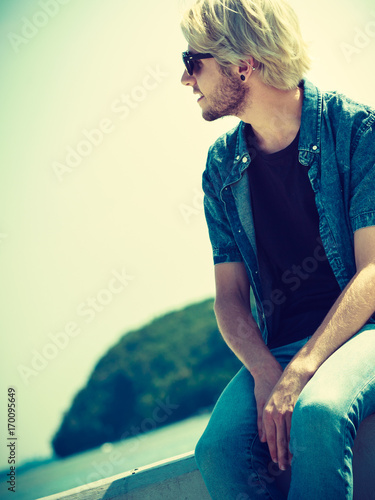 Sitting man relaxing, enjoying summertime photo