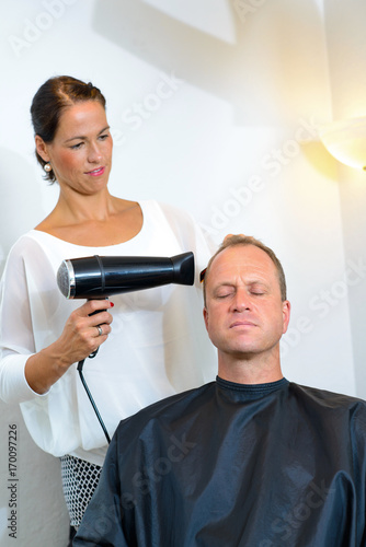 female hairdresser cutting hair of man