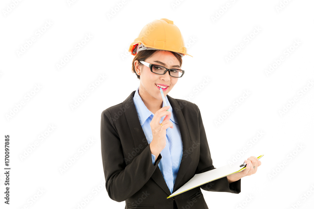 Young attractive confident asian woman, orange safety hat, glass, black suit, blue shirt on white background writing on notepad Young attractive confident asian woman, orange safety hat, glass, black suit, blue shirt on white background writing on notepad