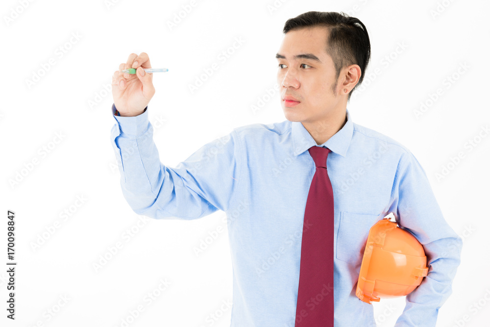Young attractive confident Asian male engineer in blue shirt red tie orange helmet holding pen writing pose on white background Young attractive confident Asian male engineer in blue shirt red tie orange helmet holding pen writing pose on white background