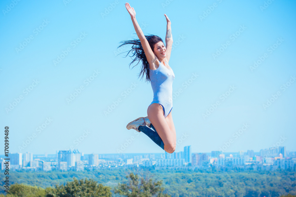 Young woman take a sport and gymnastic in city park. Concept of good health and sport lifestyle Young woman take a sport and gymnastic in city park. Concept of good health and sport lifestyle