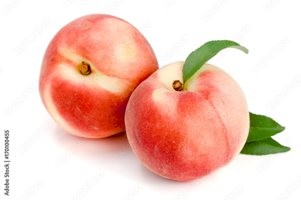 Two peaches with green leaf isolated on white background Two peaches with green leaf isolated on white background