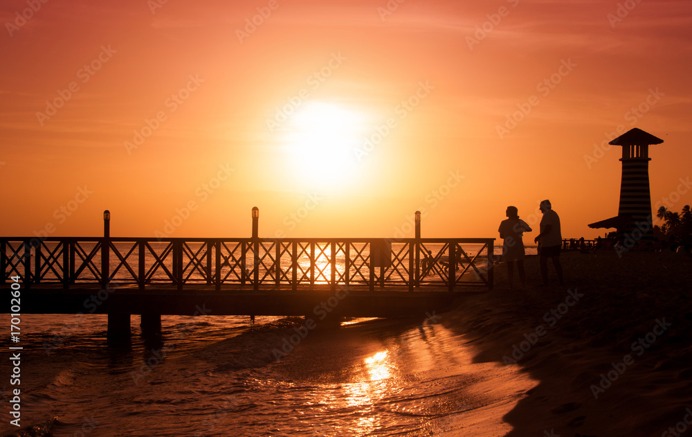 Fototapeta premium Sunset over the sea. Pier on the foreground.