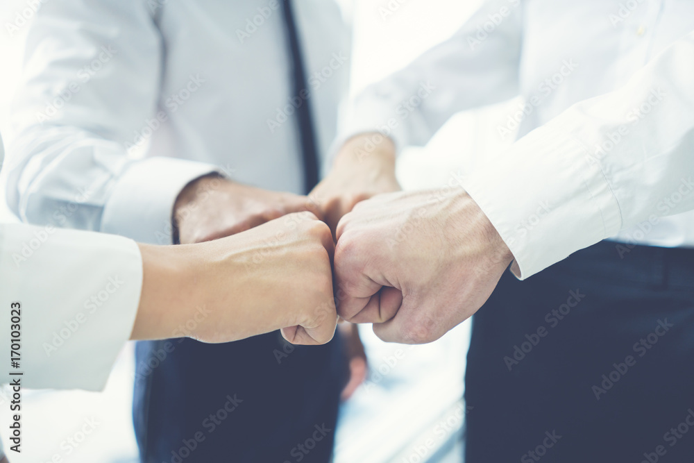 The four business people greeting with a fist The four business people greeting with a fist