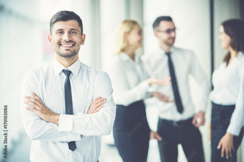 The happy businessman stand near partners The happy businessman stand near partners
