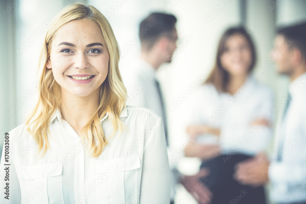 The businesswoman smile near the colleagues