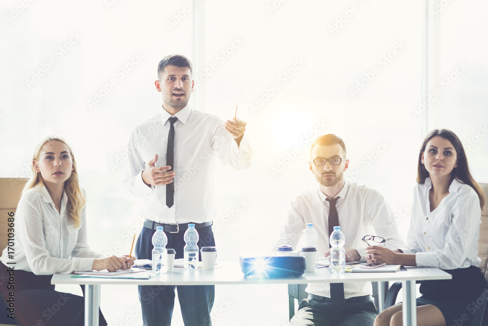 The business people discuss a presentation on the sunny background The business people discuss a presentation on the sunny background