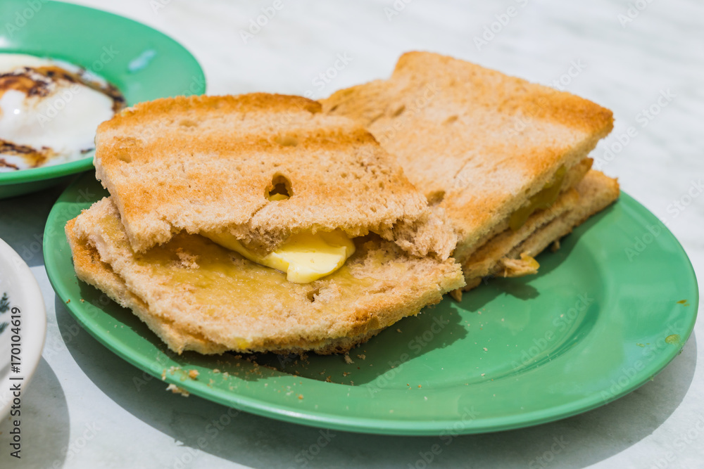 Singapore Breakfast Kaya Toast, Coffee bread and Half-boiled eggs Singapore Breakfast Kaya Toast, Coffee bread and Half-boiled eggs
