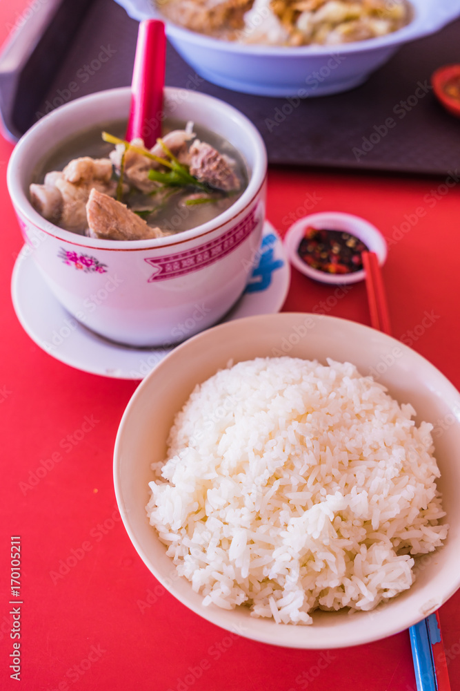 Pork Spare Ribs Soup with Rice on red table background Pork Spare Ribs Soup with Rice on red table background