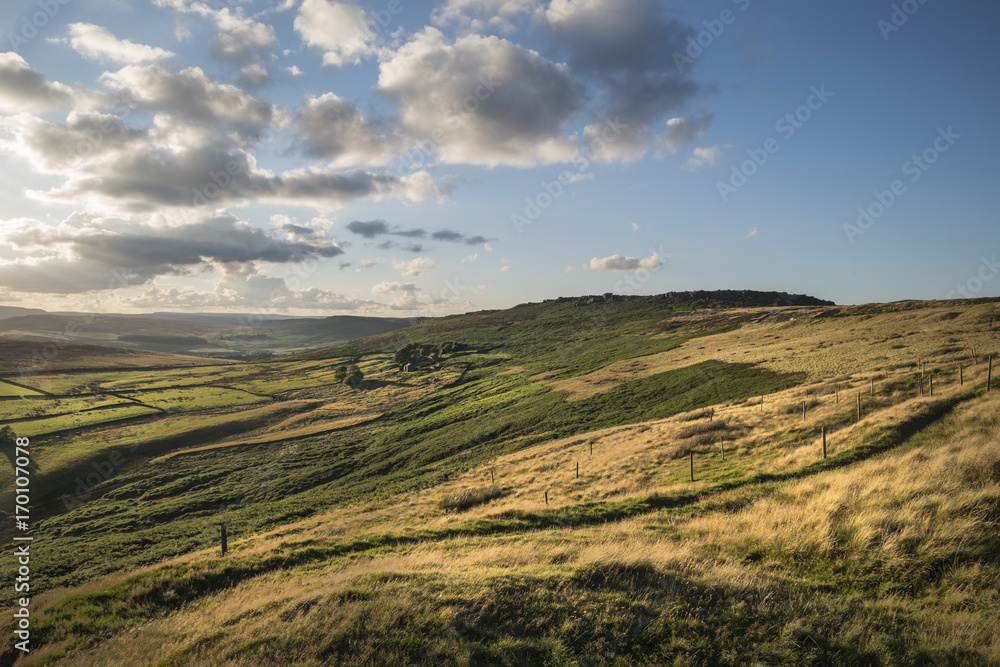 Beautiful vibrant landscape image of Burbage Edge and Rocks in Summer in Peak District England