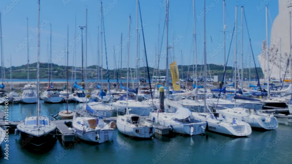 marina with boats and monument to colon in lisboa marina with boats and monument to colon in lisboa