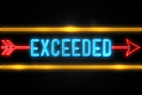 Exceeded  - fluorescent Neon Sign on brickwall Front view
