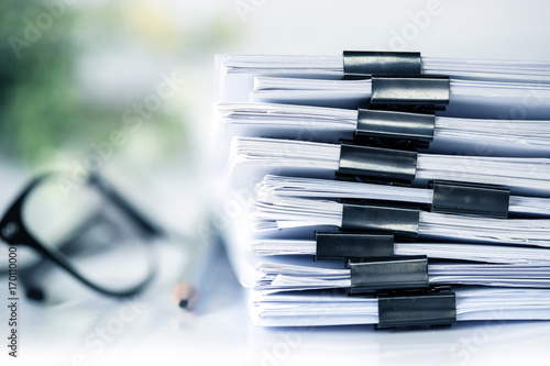 extreamly close up the stacking of office working document with paper clip folder photo