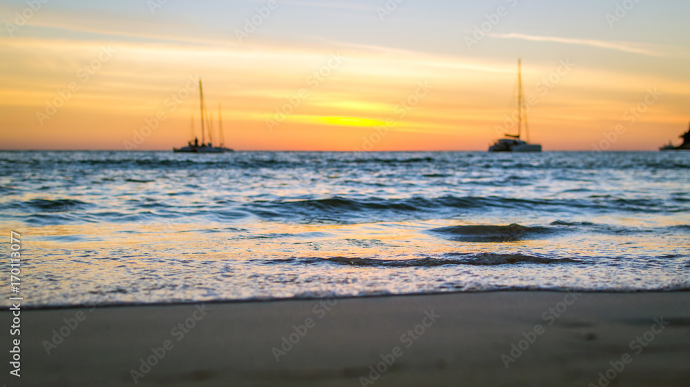 Soft waves on the sand at sunset. Selective focus. Soft waves on the sand at sunset. Selective focus.