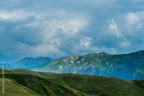 Mountain valley with snow peaks and clouds in Tetnuldi, Mestia, Georgia © irimeiff