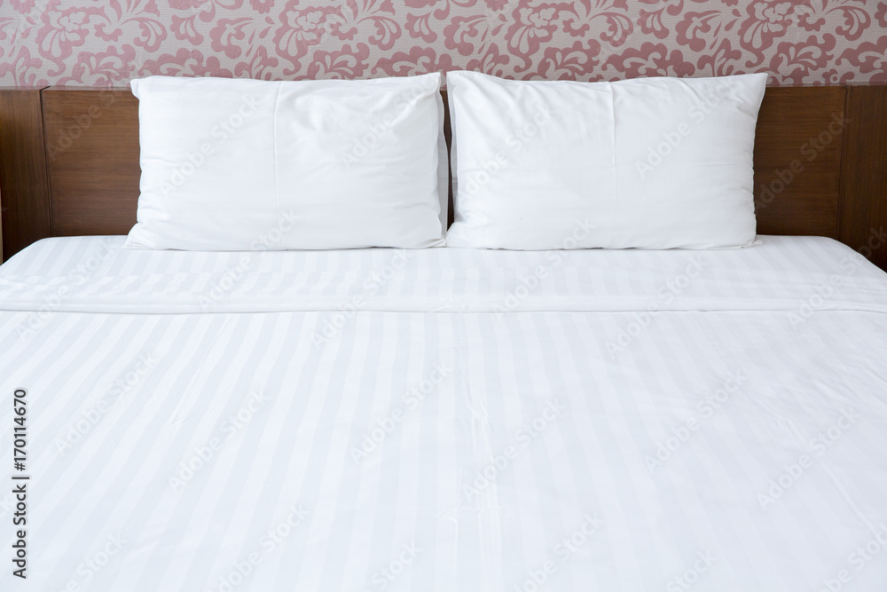 Obraz premium White pillows and bed in bedroom