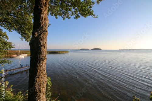 Fototapeta Naklejka Na Ścianę i Meble -  A scenic early morning panorama of the Sniardwy lake with Wyspa Pajecza and Czarci Ostrow islands visible in the background.