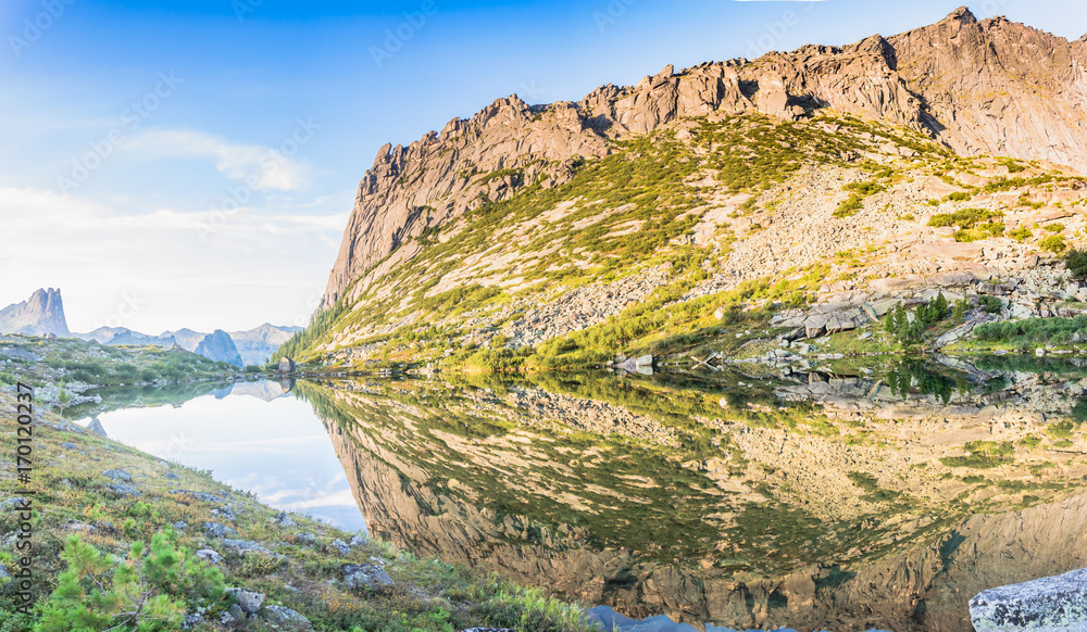 Naklejka premium Reflections of rocks and mountains in the lake