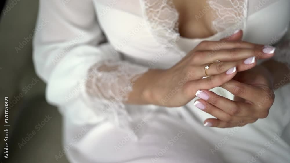 Young woman in lingerie put on ring on a finger Young woman in lingerie put on ring on a finger