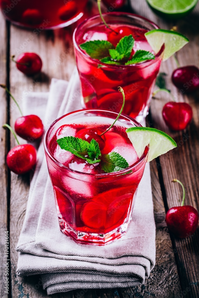 ice refreshing cherry sangria in glass with ice cubes, lime and mint ice refreshing cherry sangria in glass with ice cubes, lime and mint