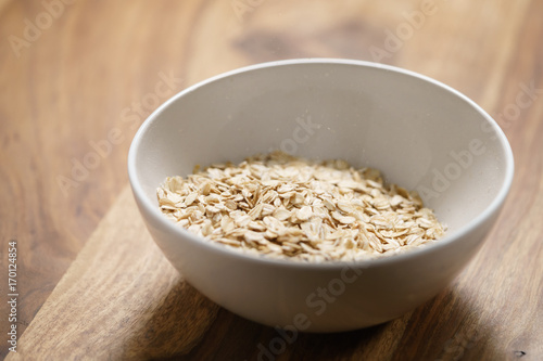 oat flakes in white bowl on wood table