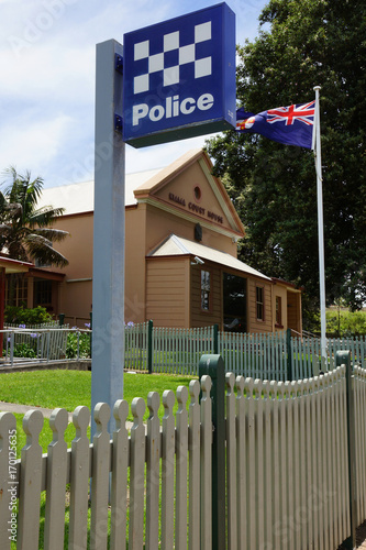 Kiama Court House in Australia with police sign and australian flag in foreground. photo