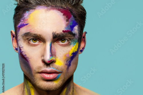 Male face, makeup art. Handsome caucasian man close up. The bold look.