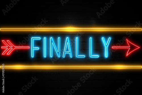 Finally  - fluorescent Neon Sign on brickwall Front view photo