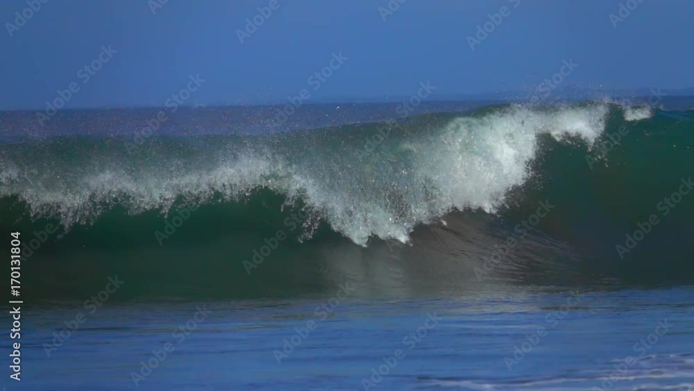 SLOW MOTION, CLOSE UP: Big barrel wave rolling and crashing on shallow sandbars in the ocean. Huge tropical tube wave breaking and splashing water drops. Violent powerful surf sea wave collapsing SLOW MOTION, CLOSE UP: Big barrel wave rolling and crashing on shallow sandbars in the ocean. Huge tropical tube wave breaking and splashing water drops. Violent powerful surf sea wave collapsing