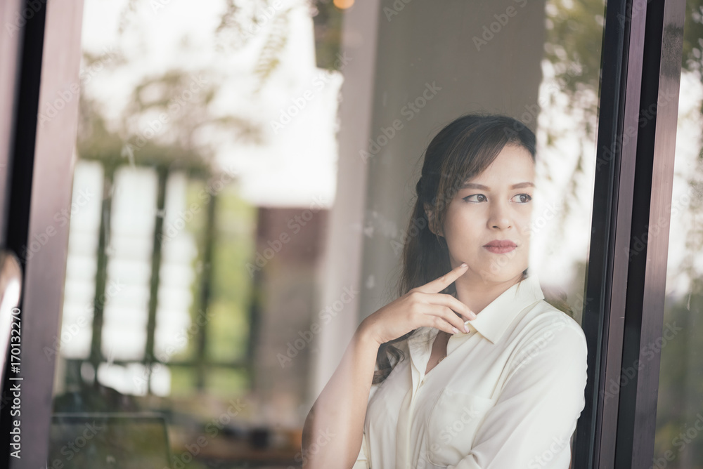 View of Through a glass window, Asian girl business thinking ide View of Through a glass window, Asian girl business thinking ide