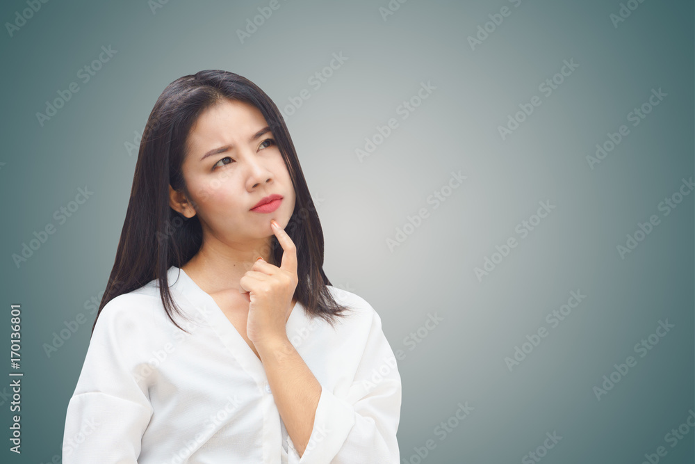 portrait of beautiful Asian business woman thinking look at copy space over grey wall background portrait of beautiful Asian business woman thinking look at copy space over grey wall background