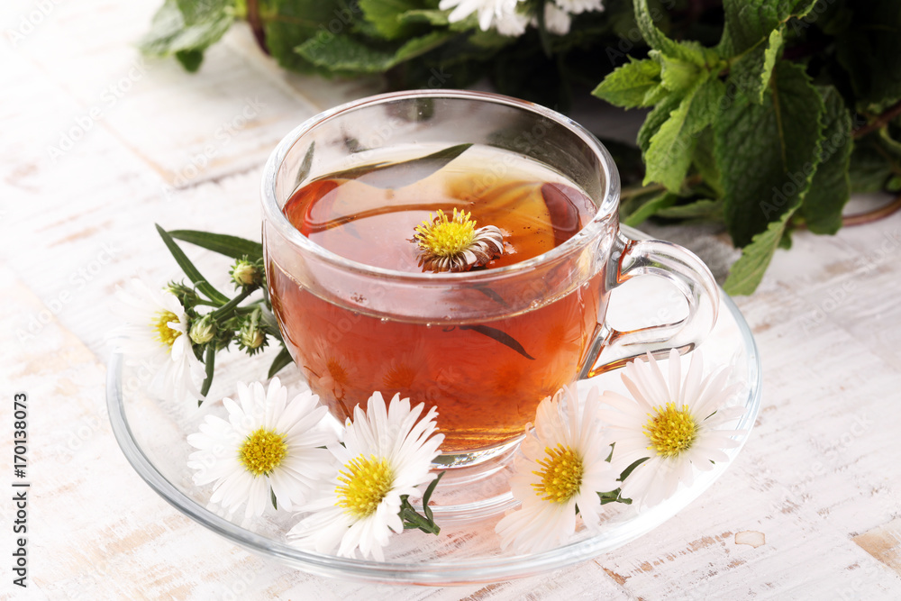 cup of tea with chamomile flowers on rustic background cup of tea with chamomile flowers on rustic background