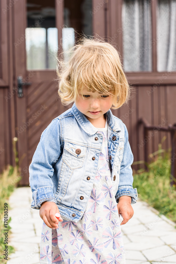 Sad lovely little baby girl walks outdoors Sad lovely little baby girl walks outdoors