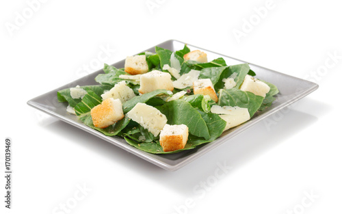caesar salad in plate on white background