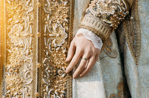 Clothes of a historical imperial woman with pastel tones, a hand with a ring with a precious stone © aapsky