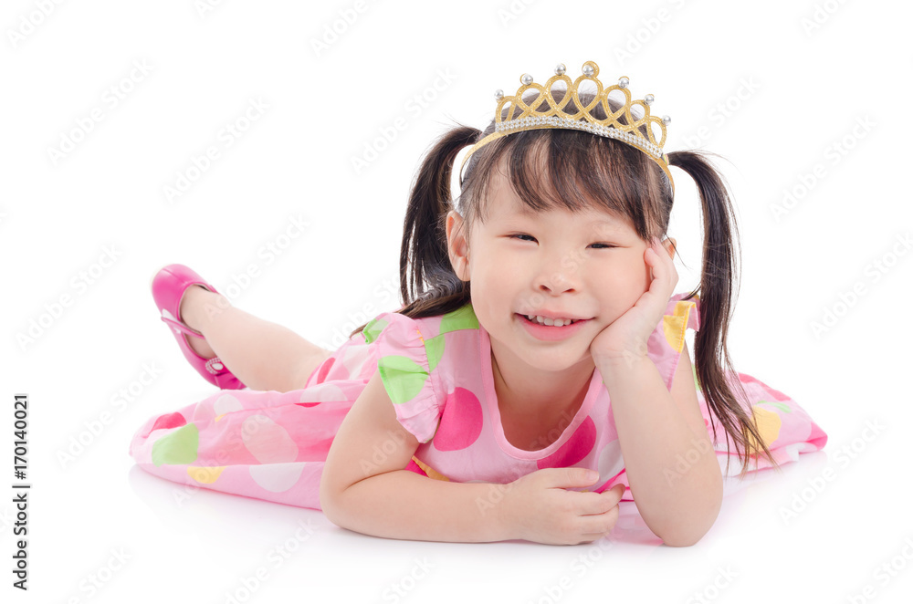 Little asian girl wearing pink color dress with crown smiling on the floor Little asian girl wearing pink color dress with crown smiling on the floor