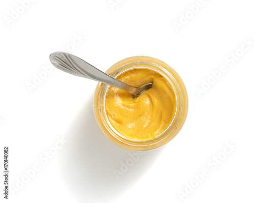 mustard sauce in plate on white background
