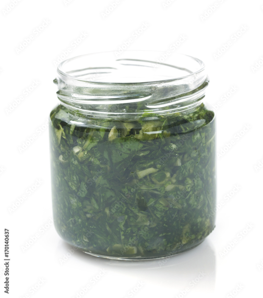 pesto sauce in jar on white pesto sauce in jar on white