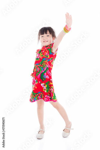 Little asian girl wearing red chinese traditional dress standing over white background