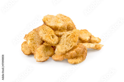 Billede på lærred Heap of croutons from baguette with spices for beer on a white background