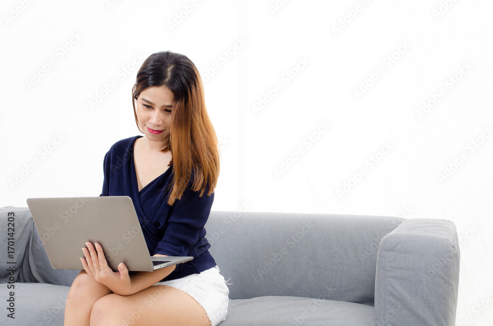 happy beautiful young asian woman using laptop computer on on sofa at home on white background, soft focus, lifestyle smart communication technology, online shopping and payment online concept happy beautiful young asian woman using laptop computer on on sofa at home on white background, soft focus, lifestyle smart communication technology, online shopping and payment online concept