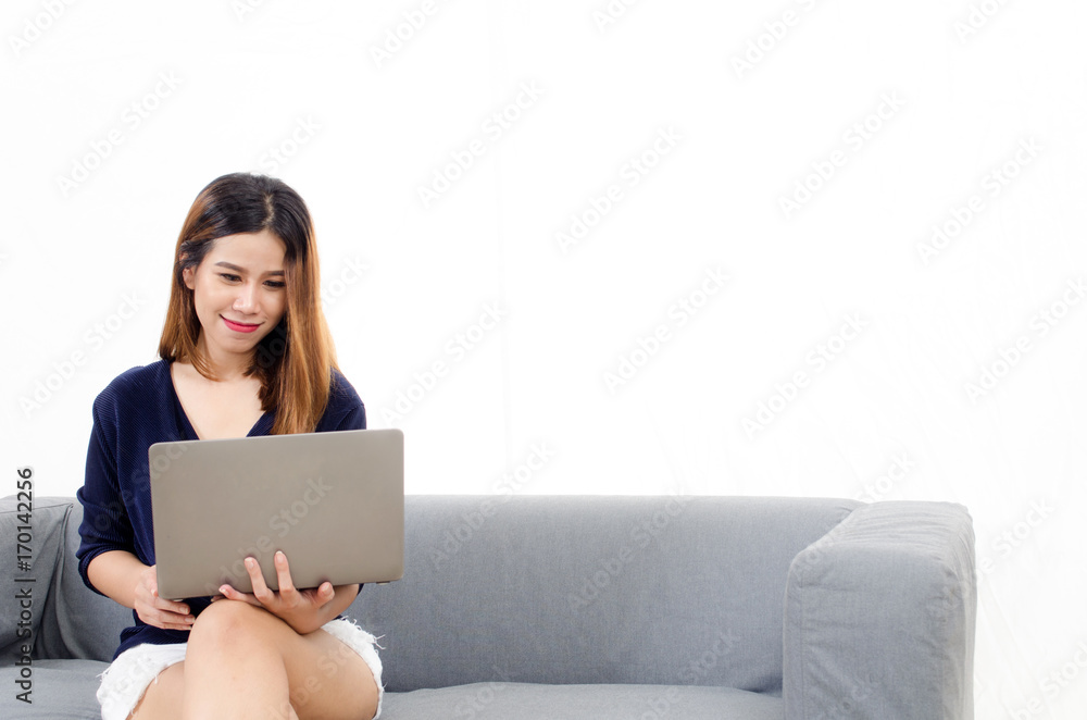 happy beautiful young asian woman using laptop computer on on sofa at home on white background, soft focus, lifestyle smart communication technology, online shopping and payment online concept happy beautiful young asian woman using laptop computer on on sofa at home on white background, soft focus, lifestyle smart communication technology, online shopping and payment online concept