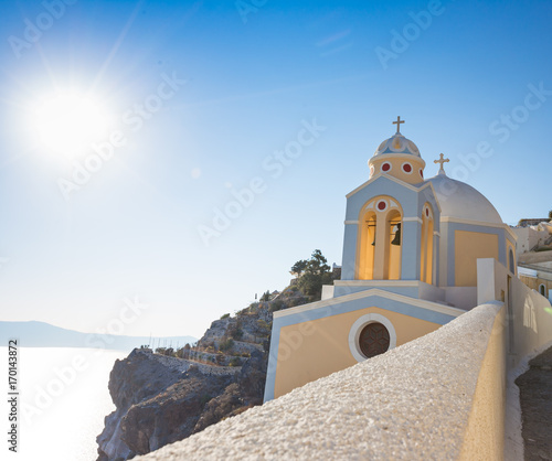 Beautiful yellow church dome on the edge of the town of Fira.