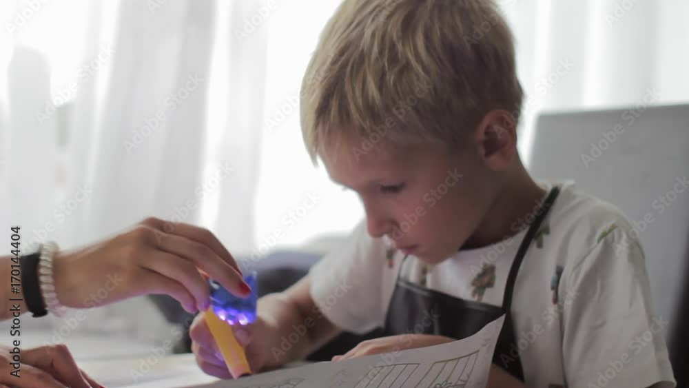 Mom helping his son to do his homework Mom helping his son to do his homework